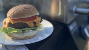 a burger next to a grill